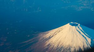 Stunning aerial view of Mount Fuji's snow-capped peak during winter, capturing its majestic beauty.